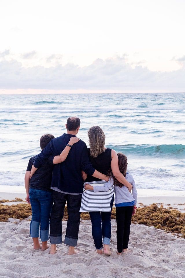 A family staring out at the sea