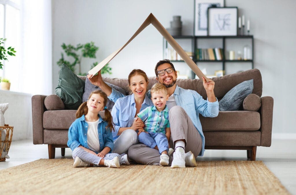 happy family mother father and kids with roof at a home