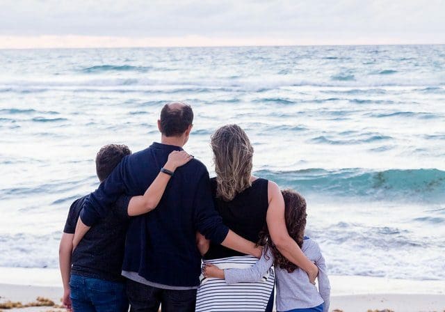 A family staring out at the sea